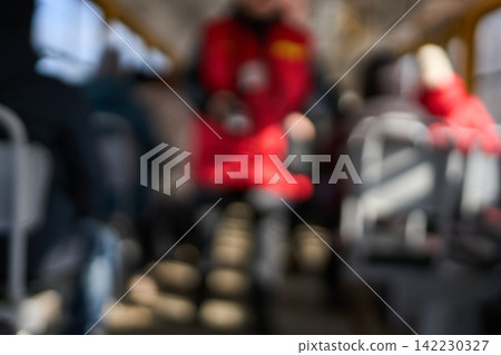 Blurred Passengers Seated And Standing Inside Moving Bus With Indistinct Figures Wearing Coats Blurred Passengers Seated And Standing Inside Moving Bus With Indistinct Figures Wearing Coats 142230327