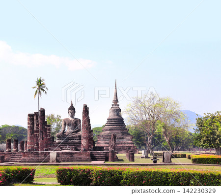 Ancient stone Buddha statue, Wat Sa Si temple, Sukhothai historical park. Picturesque scene with Buddha statuary, Sukhothai old city, Northern Thailand. Topic of vacation, travel, trip, cruise, tour Ancient stone Buddha statue, Wat Sa Si temple, Sukhothai historical park. Picturesque scene with Buddha statuary, Sukhothai old city, Northern Thailand. Topic of vacation, travel, trip, cruise, tour 142230329