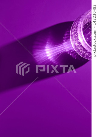 Glass Bottle Casting Radial Light Pattern On Magenta Background In Closeup Shadow Study Glass Bottle Casting Radial Light Pattern On Magenta Background In Closeup Shadow Study 142230482