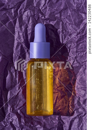 Glass Dropper Bottle Containing Yellow Oil On Crumpled Purple Paper Backdrop Casting Distinct 142230486