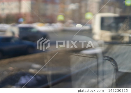 Urban Street Scene Reflected Through Bus Window With Blurred Vehicles And Interior Seat Structure Urban Street Scene Reflected Through Bus Window With Blurred Vehicles And Interior Seat Structure 142230525