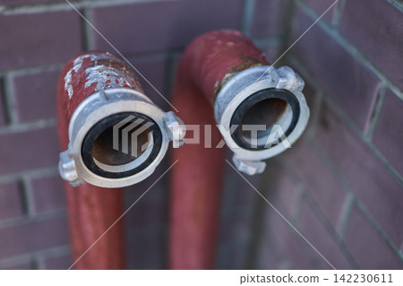 Fire Hose Outlets Mounted Capped And Weathered Against Brick Exterior Wall In Urban Alleyway Fire Hose Outlets Mounted Capped And Weathered Against Brick Exterior Wall In Urban Alleyway 142230611