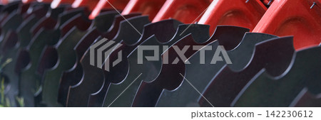 Agricultural Disc Harrow Blades Aligned On Red Frame In Close Up Detail Showing Curved Steel Discs 142230612