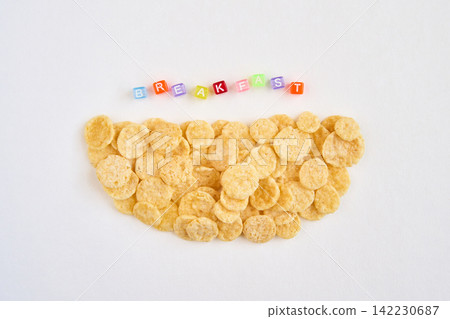 Cornflake Semicircle With Colored Letter Beads Spelling Breakfast Positioned Above On White Cornflake Semicircle With Colored Letter Beads Spelling Breakfast Positioned Above On White 142230687