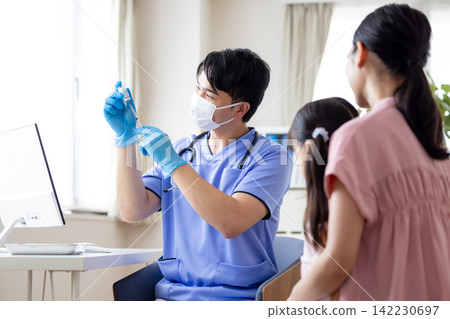 Medical - A doctor holding a syringe Medical - A doctor holding a syringe 142230697