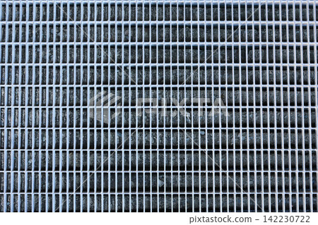 Metal Grate With Linear Shadow Patterns On Outdoor Concrete Walkway Closeup Revealing Grid Pattern Metal Grate With Linear Shadow Patterns On Outdoor Concrete Walkway Closeup Revealing Grid Pattern 142230722