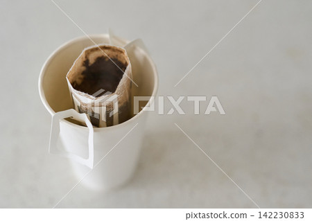 Disposable Paper Cup Containing Single Use Drip Coffee Filter With Steeped Coffee Grounds Visible Disposable Paper Cup Containing Single Use Drip Coffee Filter With Steeped Coffee Grounds Visible 142230833