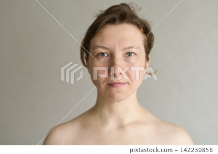 Woman Frontal Bare Shoulders Looking At Camera Plain Gray Background Studio Portrait Head Woman Frontal Bare Shoulders Looking At Camera Plain Gray Background Studio Portrait Head 142230858