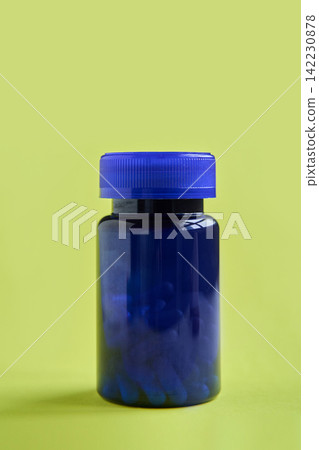 Blue Plastic Pill Bottle Standing Closed On Lime Green Studio Background With Soft Shadow Minimal Blue Plastic Pill Bottle Standing Closed On Lime Green Studio Background With Soft Shadow Minimal 142230878