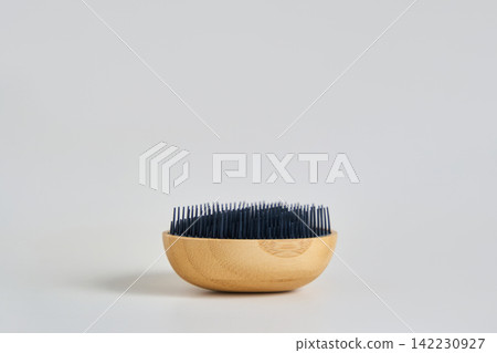 Wooden Bowl Brush With Dense Black Bristles Resting On Neutral Surface Under Soft Light In Simple Wooden Bowl Brush With Dense Black Bristles Resting On Neutral Surface Under Soft Light In Simple 142230927