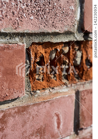 Brick Wall Showing Eroded Mortar And Exposed Aggregate In Vertical Closeup Of Damaged Red Masonry Brick Wall Showing Eroded Mortar And Exposed Aggregate In Vertical Closeup Of Damaged Red Masonry 142230934