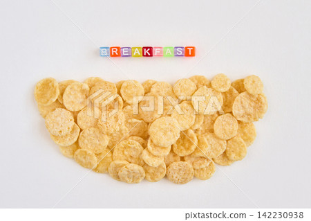 Cornflake Pile Forming Semicircle With Multicolored Block Letters Spelling Breakfast Above On White Cornflake Pile Forming Semicircle With Multicolored Block Letters Spelling Breakfast Above On White 142230938