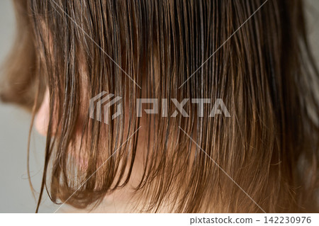 Person With Wet Brown Hair Hanging Over Face Showing Close-Up Strands Texture And Scalp Detail Person With Wet Brown Hair Hanging Over Face Showing Close-Up Strands Texture And Scalp Detail 142230976