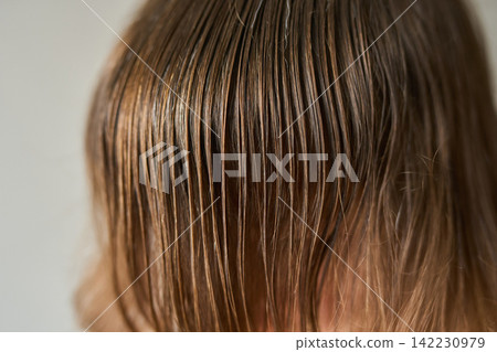 Detail Of Wet Brown Hair Draped Over Forehead Showing Fine Strand Texture And Scalp Contrast 142230979