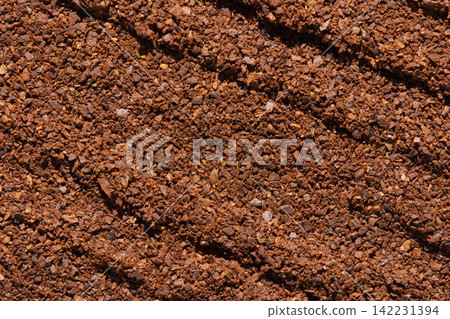 Ground Coffee Granules Raked Into Parallel Grooves On Textured Brown Surface Closeup Macro Detail Ground Coffee Granules Raked Into Parallel Grooves On Textured Brown Surface Closeup Macro Detail 142231394