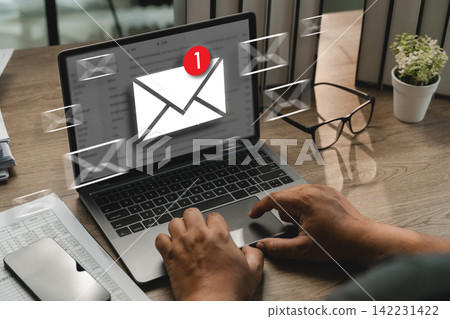 Hands checking email notification on laptop with floating mail icons, showing new email alert, inbox message update, digital communication, online notification, office workspace. Hands checking email notification on laptop with floating mail icons, showing new email alert, inbox message update, digital communication, online notification, office workspace. 142231422