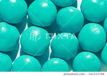 Uniform Teal Candy Spheres Arranged In Grid On Light Surface Closeup Showing Glossy Shells Uniform Teal Candy Spheres Arranged In Grid On Light Surface Closeup Showing Glossy Shells 142231586