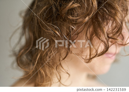 Hair Curly Closeup Profile Woman With Loose Ringlets And Textured Strands Against Neutral Backdrop Hair Curly Closeup Profile Woman With Loose Ringlets And Textured Strands Against Neutral Backdrop 142231589