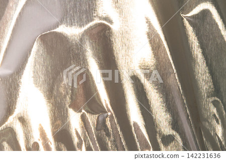 Pale Gold Champagne Metallic Foil Background With Glossy Reflective Folds For Luxury Banner Pale Gold Champagne Metallic Foil Background With Glossy Reflective Folds For Luxury Banner 142231636