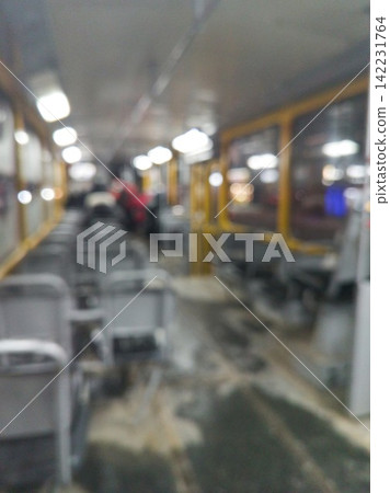 Interior Of Public Bus With Empty Gray Seats And Blurred Aisle Under Fluorescent Lights During 142231764