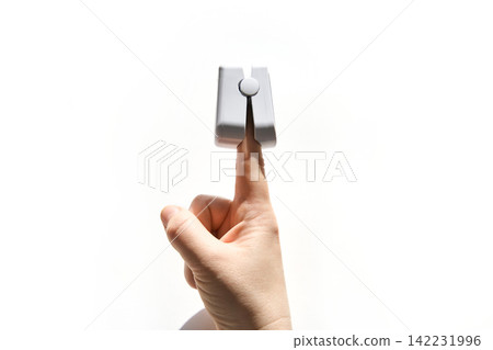 Finger Inserted Into Fingertip Pulse Oximeter Being Measured Against White Background Medical Finger Inserted Into Fingertip Pulse Oximeter Being Measured Against White Background Medical 142231996