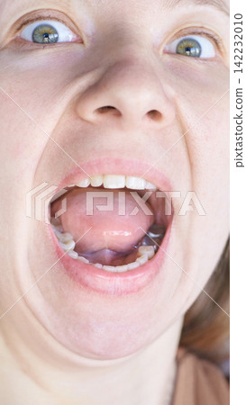 Vertical Close Up Adult Female Opening Mouth Wide With Visible Tongue Teeth And Eyes Widened Vertical Close Up Adult Female Opening Mouth Wide With Visible Tongue Teeth And Eyes Widened 142232010