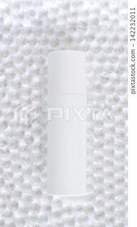 White Cosmetic Bottle Standing Upright On Textured Bubble Wrap Background With Soft Studio Lighting White Cosmetic Bottle Standing Upright On Textured Bubble Wrap Background With Soft Studio Lighting 142232011