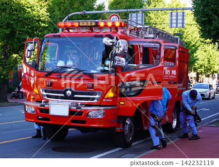 Fire department rescue vehicle and rescue team members preparing for deployment Fire department rescue vehicle and rescue team members preparing for deployment 142232119