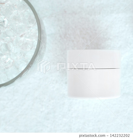 White Cosmetic Jar Positioned Beside Glass Bowl Of Clear Gel Beads On Textured White Towel In Spa 142232202