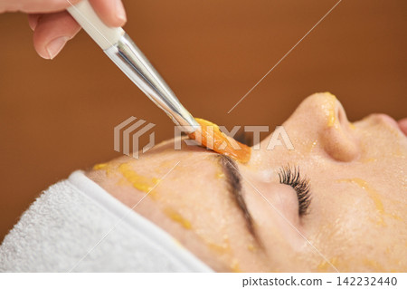 Young Female Asian Enjoying A Relaxing Facial Mask Treatment At A Spa For Skin Rejuvenation 142232440