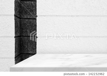 White marble table top display and black stone corner wall background for product presentation. White marble table top display and black stone corner wall background for product presentation. 142232962