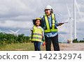 Happy children explore wind energy with a smiling adult 142232974