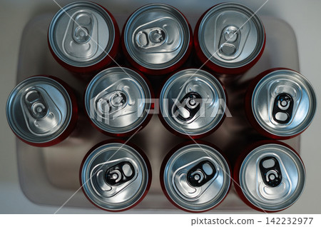 Ten soda cans sit in a tray, ready for use 142232977