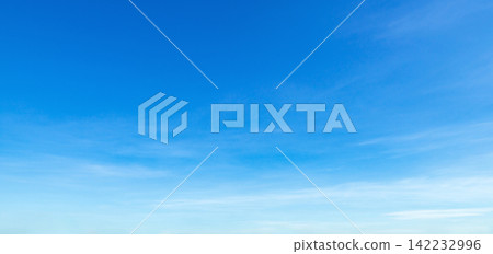 Clear blue sky with wispy clouds stretches above Clear blue sky with wispy clouds stretches above 142232996