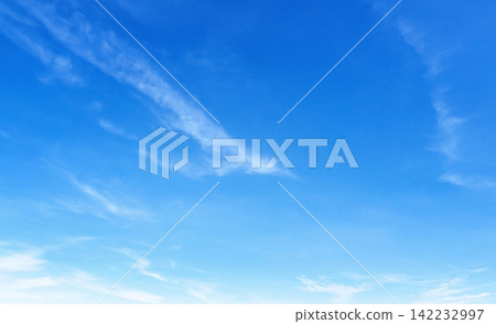 Clear blue sky with wispy clouds drifting gently Clear blue sky with wispy clouds drifting gently 142232997