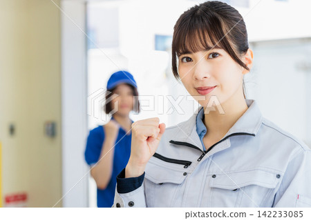 Women working in work clothes in a warehouse Women working in work clothes in a warehouse 142233085