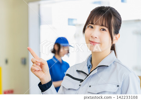 Women working in work clothes in a warehouse Women working in work clothes in a warehouse 142233108