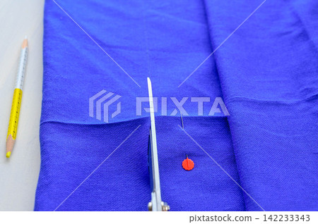 Blue fabric with finished lines and fabric scissors Blue fabric with finished lines and fabric scissors 142233343