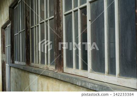 An old wooden window frame with a nostalgic atmosphere. An old wooden window frame with a nostalgic atmosphere. 142233384