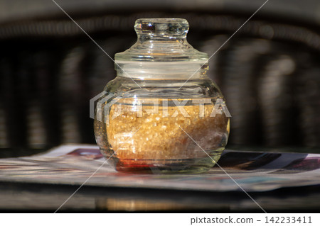 Brown sugar crystals stored clear glass jar lid representing sweetener kitchen ingredient food storage baking everyday pantry essentials Brown sugar crystals stored clear glass jar lid representing sweetener kitchen ingredient food storage baking everyday pantry essentials 142233411