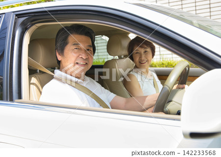 A senior couple going out in their car A senior couple going out in their car 142233568
