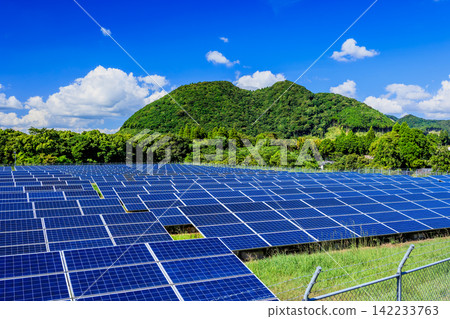 A vast solar power plant (mega solar) with a clear blue sky and midsummer clouds. A vast solar power plant (mega solar) with a clear blue sky and midsummer clouds. 142233763