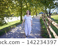 mature pregnancy with female traveler enjoying peaceful nature in green countryside 142234397