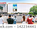 Pedestrians and tourist waiting at crosswalk in front of Parco department store in Ikebukuro Tokyo Japan 142234441
