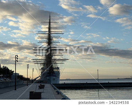 The silhouettes of the sailing ships Kaiwo Maru and Nippon Maru against the morning sky. The silhouettes of the sailing ships Kaiwo Maru and Nippon Maru against the morning sky. 142234538