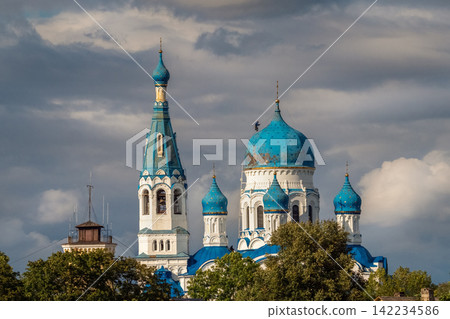 Industrial climber performing high-altitude maintenance work on the majestic blue dome of Pokrovsky Cathedral in Gatchina. 142234586