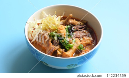rice vermicelli with northern thai curry sauce on blue background rice vermicelli with northern thai curry sauce on blue background 142234869