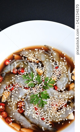 shrimp in soy sauce on white plate, korean style menu shrimp in soy sauce on white plate, korean style menu 142234870