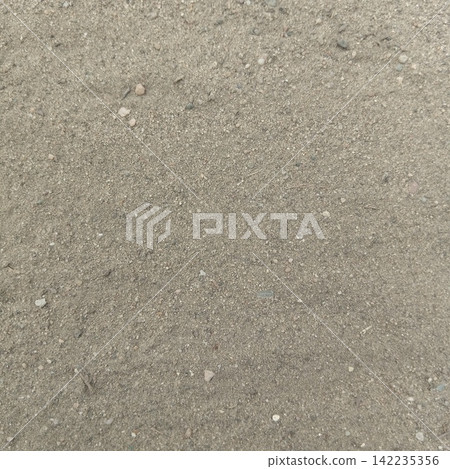 Fine dry sand and loose dirt soil ground texture surface captured outdoors in a highly detailed top down flat lay perspective Fine dry sand and loose dirt soil ground texture surface captured outdoors in a highly detailed top down flat lay perspective 142235356