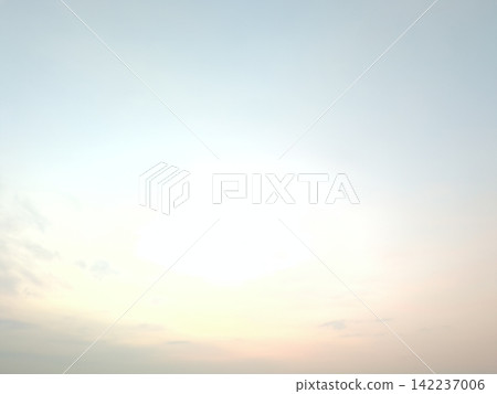 A soft, serene sky with a gradient from a light blue-gray at the top to a faint pink at the bottom. The sky is largely clear, with only a few thin, scattered clouds visible. A soft, serene sky with a gradient from a light blue-gray at the top to a faint pink at the bottom. The sky is largely clear, with only a few thin, scattered clouds visible. 142237006